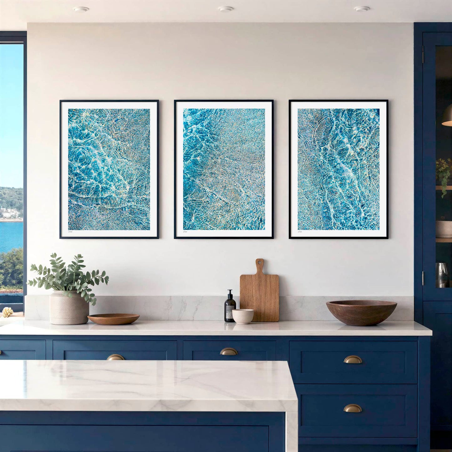 three images from the KOKO Studio Porthcothan Sapphire collection of fine art coastal inspired prints framed on a wall in a modern interior kitchen